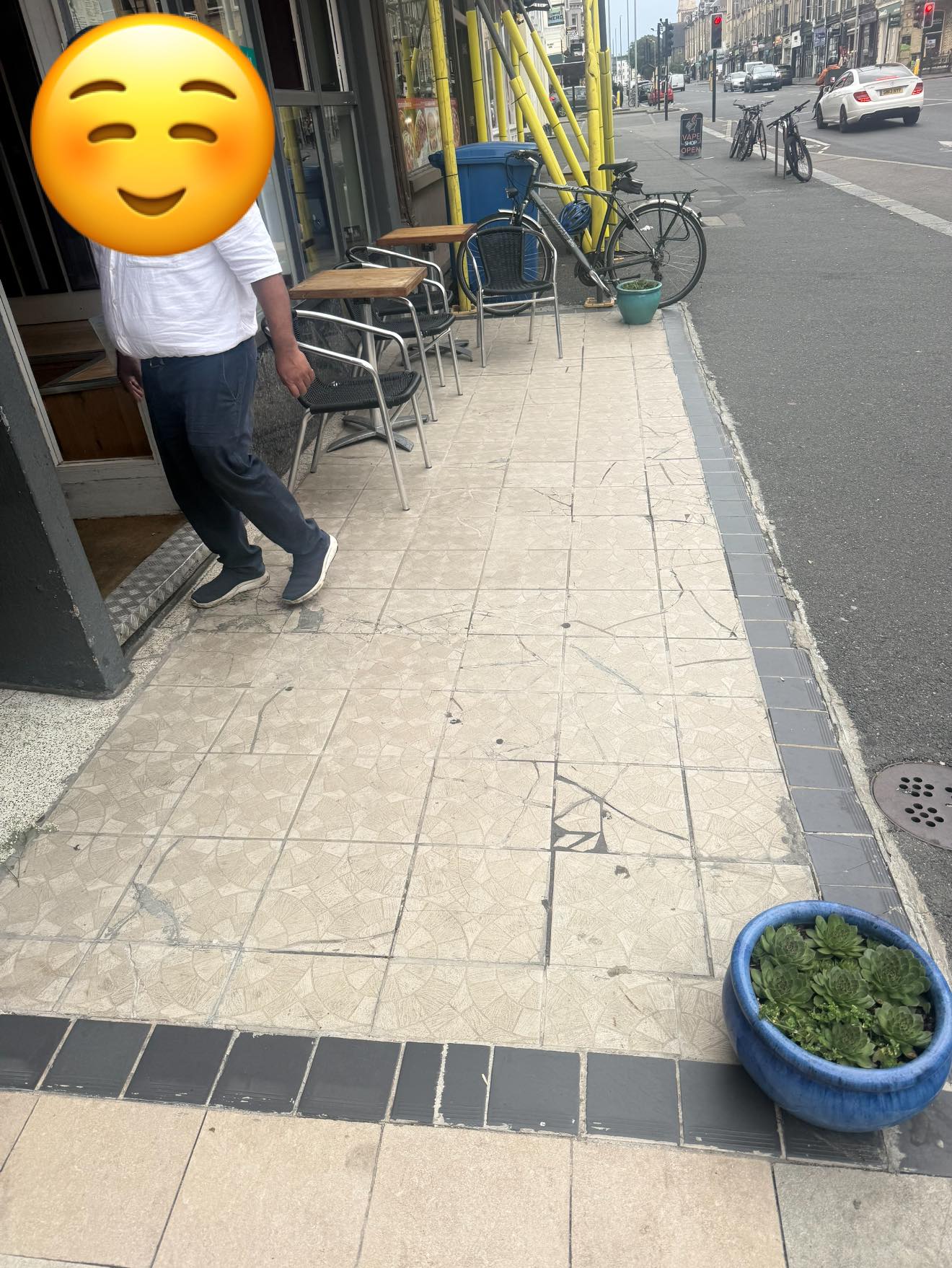 Before — cracked shopfront tiles and damaged border