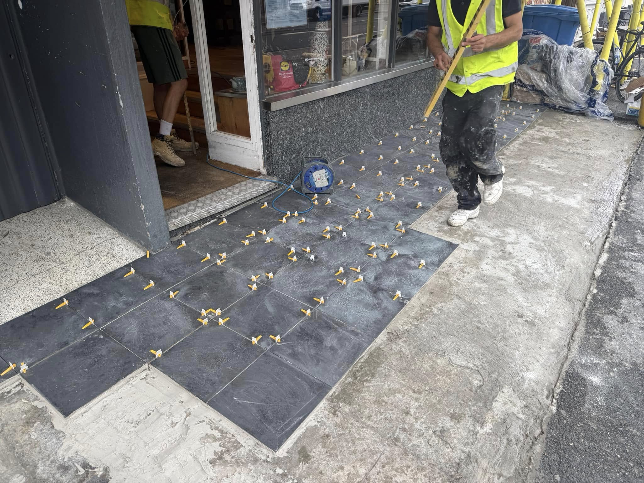 After — refreshed shopfront tiles with neat dark border